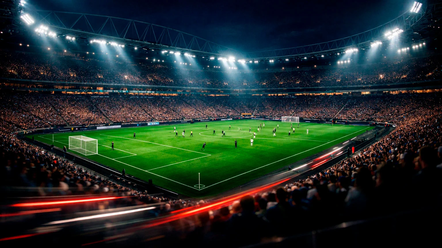 Fußballstadion bei Nacht mit dramatischer Beleuchtung und Spielern auf dem Feld